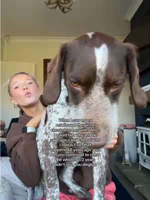 The cover image features a young woman holding a dog. The woman has blonde hair and is looking towards the camera. The dog is a brown and white dog. There is text overlayed on the image as well.