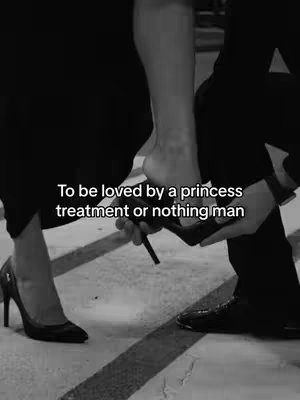 A black and white image shows the lower legs and feet of two people. One person, wearing a high-heeled shoe, is having the shoe put on by the other person. Text overlays the image.