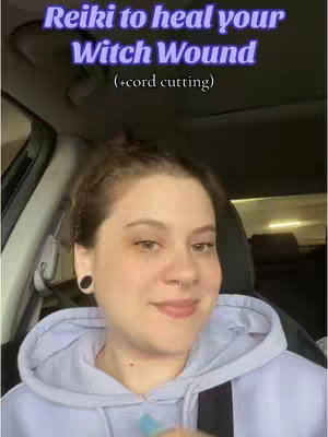 A woman sitting in a car with text overlayed. She is smiling with a relaxed expression, wearing a light blue hoodie. The background is blurred, showing the car interior and some outdoor light.