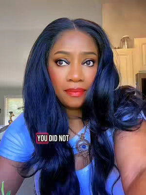 A woman with long, dark blue hair looks directly at the camera. She has on makeup with red lipstick and a blue top. A text overlay says 'YOU DID NOT' in a red box.
