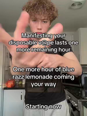 A young man with curly blonde hair is holding his hand out toward the camera. Overlayed text is written on the image.