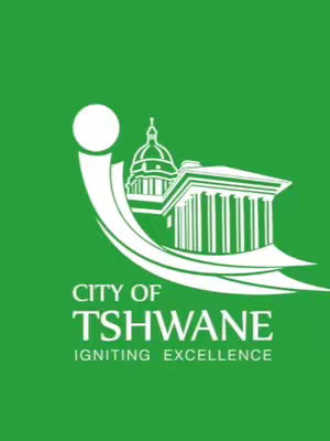 A green logo of the City of Tshwane, featuring a curved white shape representing the letter 'i', a white building with columns and a dome, and the text 'CITY OF TSHWANE' above 'IGNITING EXCELLENCE' in white.