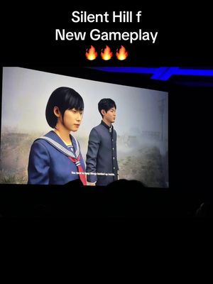 The image shows a view of a screen where elements from the game "Silent Hill f" are being displayed. On the left side of the screen, there is a person in a girl's school uniform, and on the right side, there is a person in a boy's school uniform. Above the screen, there is text that says "Silent Hill f New Gameplay". Below the screen, there is the dark background.