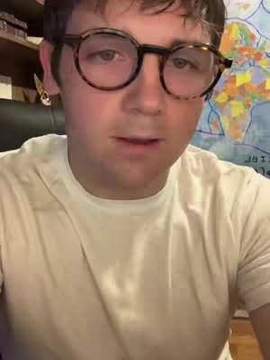 The cover image is a selfie of a person wearing glasses and a white shirt. In the background, there is a map and wooden paneling. The lighting suggests an indoor setting.