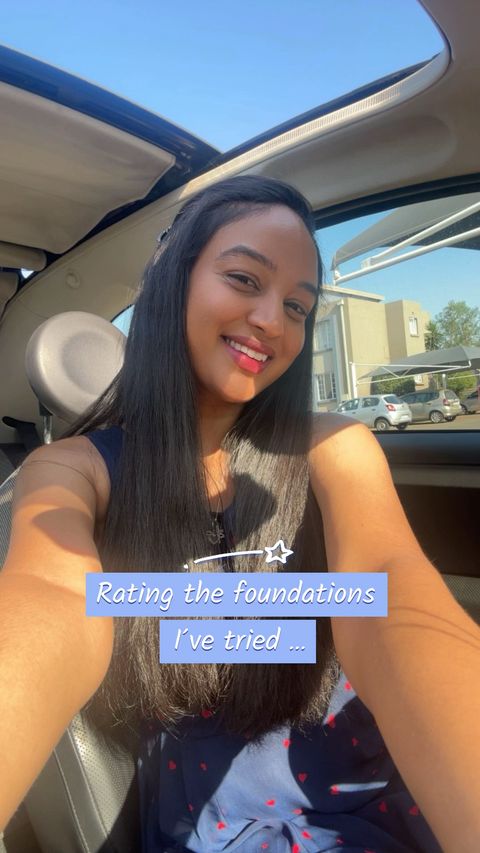 A selfie of a woman inside a car with the sun shining. The woman is smiling and looking towards the camera. Text over is on a blue square