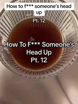 The image shows a close-up, slightly angled view into a clear glass, presumably filled with a dark liquid. The liquid creates a circle near the image center. The top of the glass appears out of focus. Superimposed on top of the liquid is white text, including the series 'Pt. 12'. The background is a lighter, possibly white, color. The overall composition is simple, with high contrast between the text and the dark liquid. The lighting is not very defined, and it is unclear how the scene is illuminated
