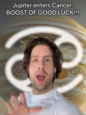 The cover image features a man with brown hair and a lip piercing looking directly at the camera with his mouth open. A white Cancer symbol is behind him, and the background has a blurry, mottled texture with gold and brown tones. Text overlays at the top read "Jupiter enters Cancer: BOOST OF GOOD LUCK!!!"