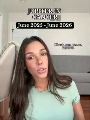 A woman with long brown hair is looking towards the camera while speaking. Text overlays include "JUPITER IN CANCER" at the top in a bold, sans-serif font, and "June 2025 - June 2026" in a black box underneath, with a smaller text overlay in the bottom right.