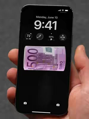 An iPhone is held in a hand, displaying its lock screen. The screen features a black background with the time, date, and weather icons at the top. A roll of five hundred Euro bills serves as the wallpaper in the center of the screen.