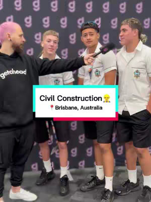 A man with pink hair is interviewing four young men on a street. They are standing in front of a wall patterned with the letter "g". A text box overlayed reads "Civil Construction" with the location "Brisbane, Australia".
