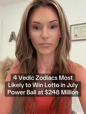 A woman with long brown hair and makeup stares directly at the camera. Text overlaid on a dark bar at the bottom of her chest reads, '4 Vedic Zodiacs Most, Likely to Win Lotto in July, Power Ball at $248 Million.' The background includes a blurred neutral-colored wall and a framed item.