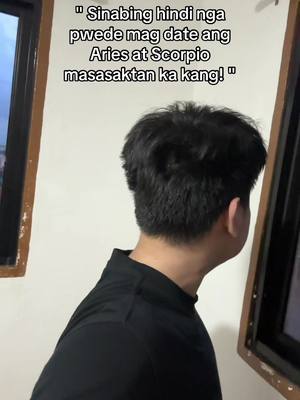 A person is shown from the back, facing towards a window, likely looking outside. The person is wearing a black shirt. Text overlays the top part of the image, written in white.