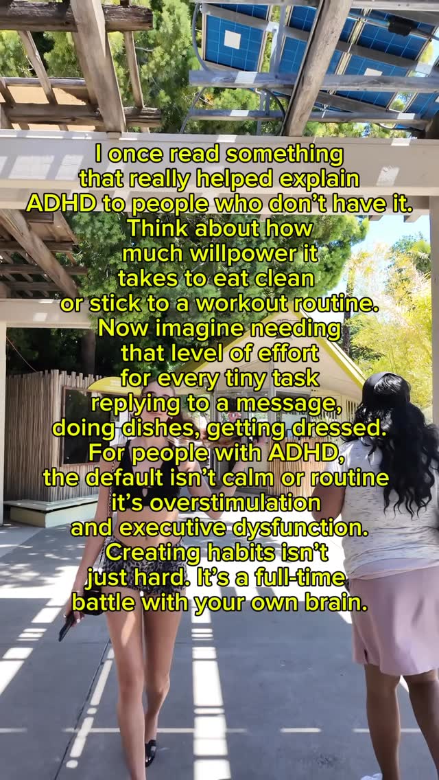 A person walking along a stone pathway, the camera follows them while text is overlaid on the image.