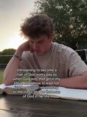 A young man is seated outdoors, resting his head on his hand and looking down at an open book, implying a moment of reflection or study. Text is overlaid on the image.