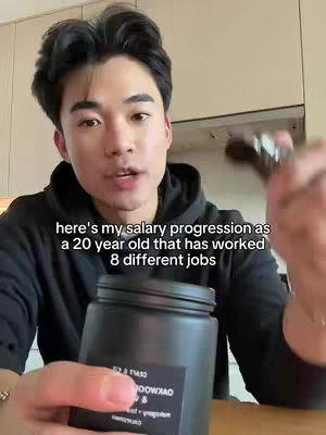 A young Asian man in a black hoodie is holding a black jar and speaking, with text overlayed on the image. The background shows a cabinet.