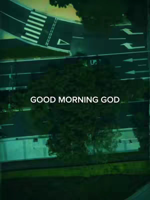 An overhead shot captures a road scene with a crosswalk, arrows, and trees, all in muted green tones. The text overlay "GOOD MORNING GOD" is positioned centrally.