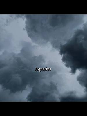 The cover features a cloudy sky, with shades of gray dominating the frame. The word "Aquarius" is overlaid on the image.
