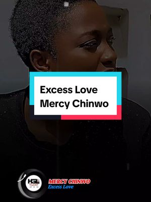 The cover image is a vertical video screenshot. The frame is dominated by a person in the medium shot, slightly off-center to the right, with the background out of focus. A text overlay in a rectangular box features the song title and artist. The background is dark and indistinct, with the person wearing a dark top. A logo is present at the bottom.