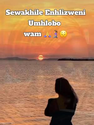A scenic view of a sunset over the ocean with a person standing facing the view. Text overlays are present.