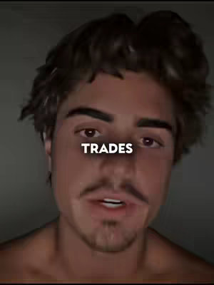 A close-up shot of a young man with dark hair, a mustache, and a slight stubble. The image is slightly blurred, with a gray background. The man has a serious expression, and the word 'TRADES' is superimposed over his face, in a white, bold font.