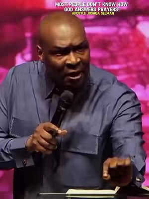 The cover image shows a medium shot of a bald Black man speaking animatedly into a microphone. The background is blurry light and dark pink. The man is wearing a blue button-down shirt and appears to be in a church or auditorium setting. Text overlay at the top reads, "MOST PEOPLE DON'T KNOW HOW GOD ANSWERS PRAYERS!" and "APOSTLE JOSHUA SELMAN".