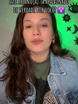 A medium shot features a woman with long, wavy brown hair. She's wearing a green t-shirt under a denim jacket and has earrings. The background is a gradient of green. Text overlays at the top ask if an Aries is in love. Decorative elements such as stars, moons, and eyes are visible on the sides.