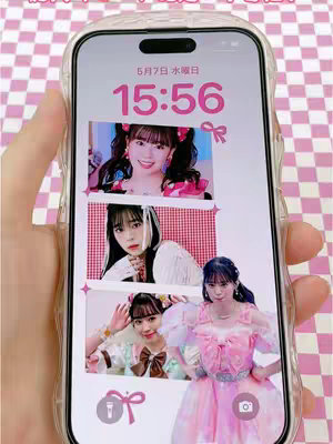 A person's hand holds a smartphone displaying a custom lock screen featuring a pink and white checkered pattern and images of three young women. The lock screen shows the date and time, as well as icons on the bottom. The background suggests a playful, feminine aesthetic.
