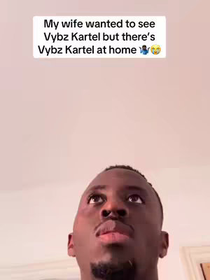 The cover image is a selfie-style shot of a Black man looking upward with a slight frown. Above him is a white rectangle containing the text overlay: "My wife wanted to see Vybz Kartel but there's Vybz Kartel at home 😭😂". The background is a light beige color that looks like a wall.