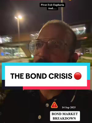 A selfie-style video cover image featuring a man with glasses set against a blurry outdoor background at night. Text overlays include the title "THE BOND CRISIS" in a large white font on a turquoise and red background, and additional text regarding the date and "BOND MARKET BREAKDOWN". The overall composition uses a mix of text and imagery aimed at conveying financial news or analysis.
