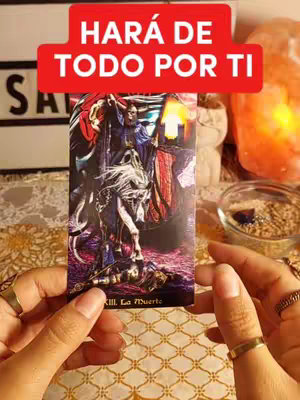 A person's hands are holding a tarot card with an ornate design, and a red banner with white text is at the top. In the background, there's a blurry setting with a bowl. The overall composition has a mystical and intimate aesthetic.