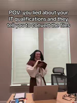 The image shows a person dressed in religious garb, holding a book, with a laptop in front of them, suggesting a humorous take on the IT qualifications. The background includes blinds and office furniture.