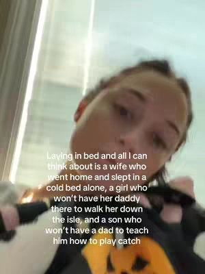 The image shows a close-up of a person lying in bed, with the camera looking up at them. The background is blurred, suggesting an indoor setting. The person appears to be looking into the camera, with a facial expression that is hard to determine because of the angle of the shot. Text is overlaid on the image.