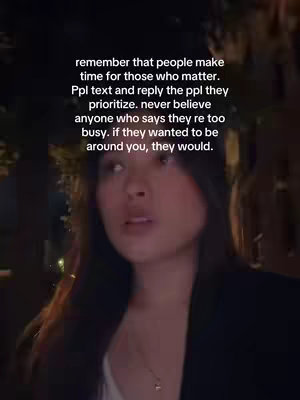 A medium shot features a woman with long dark hair and a neutral expression. She appears to be outdoors at night, with a dark background subtly lit by ambient light.