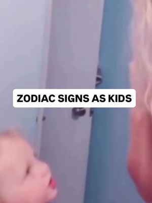 The image features a baby’s face in the foreground with the text overlay 'ZODIAC SIGNS AS KIDS'. Background shows the corner of a room with a wall in baby-blue