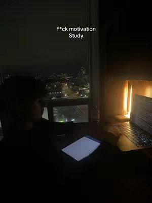 A person sits in front of a laptop and a window overlooking a city at night. Text is overlaid at the top of the image.
