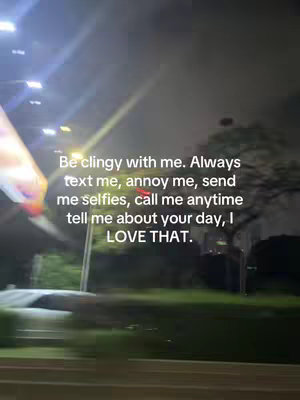 The image shows a blurry nighttime scene viewed from a moving vehicle. The main focus is on white text overlayed on the image, with lit streetlights and the vague outline of trees and a car visible in the background. The overall feel is a mix of motion and sentimentality.