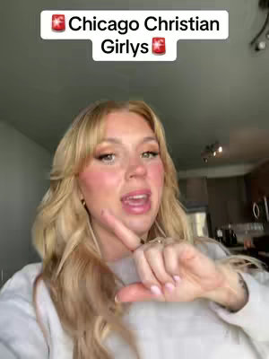 A woman with blonde hair and makeup is pointing with her right index finger, with text overlayed on the image