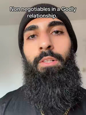 A man with a black beanie and beard looks directly at the camera. Text overlay in the background.