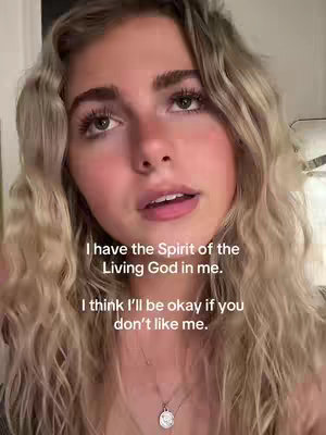 A close-up shot of a young woman with long, wavy blonde hair, looking slightly upwards. She is wearing a necklace with a pendant. Text overlays are present, with a neutral background.