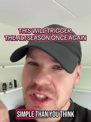 A man with short brown hair wearing a black baseball cap and a black shirt is the main subject. Text overlays in red and white are placed above and below his face. The background is a blurred interior.