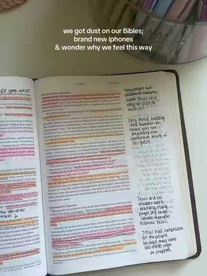 An open Bible on a white surface, with highlighted passages in yellow and pink. Handwritten notes are visible on the right page, and the text overlay states a related quote.