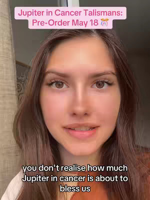 The cover image features a close-up of a woman's face. She has brown hair and is looking directly at the camera, with a neutral expression. Above her head is a pink banner with white text that reads: "Jupiter in Cancer Talismans: Pre-Order May 18". Below her, white text reads: "you don't realise how much Jupiter in cancer is about to bless us". The overall composition and lighting are natural, with a focus on the woman's face.