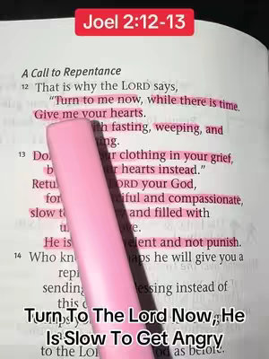 The image shows an open book with a passage from Joel 2:12-13 highlighted in pink. A pink highlighter is placed diagonally across the text. The text at the bottom says "Turn To The Lord Now; He Is Slow To Get Angry".