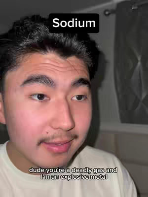 A selfie style shot of a young man with dark hair and a mustache. The top of the frame has a black banner with the word 'Sodium'. A speech bubble with text at the bottom.