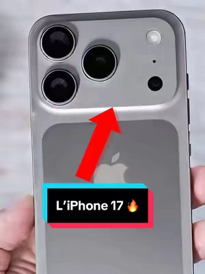 The image is a phone, presumably an iPhone, with a complex camera housing on its back. In the center, there is the Apple logo. A large red arrow points towards a text overlay at the bottom: 'L'iPhone 17' with a flame emoji.