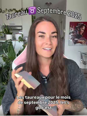 A woman with long brown hair is centered in the cover image, smiling at the camera while holding up a deck of cards. Above her, the text "Taureau Septembre 2025" is displayed with a bull symbol, indicating an astrology reading. The background includes an indoor setting, with subtle hints of greenery, suggesting a home or studio environment. The overall composition is designed to attract viewers interested in astrology or tarot readings.