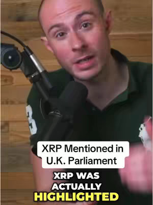 A man in a green polo shirt speaking into a microphone. Text overlays state, "XRP Mentioned in U.K. Parliament" and "XRP WAS ACTUALLY HIGHLIGHTED". The background features wooden siding.