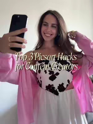 A woman in a pink open shirt and a white cow-print top takes a selfie with a black phone held in her left hand, smiling. The text overlayed on the image reads 'Top-3 Picsart Hacks for Content Creators'.
