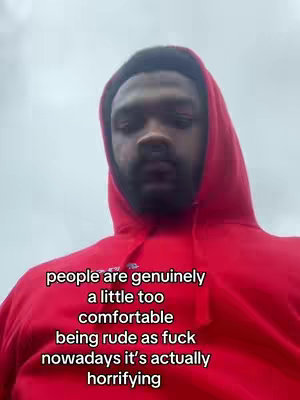 A selfie-style shot featuring a man in a red hoodie against a cloudy sky background. Text overlayed focuses on commentary about behaviors.