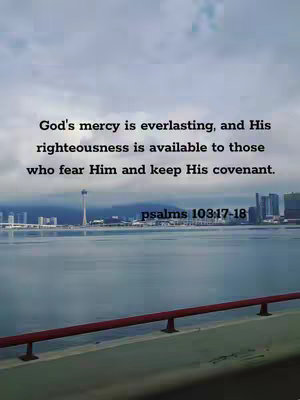 The image shows a serene outdoor scene with a calm body of water in the foreground and a city skyline in the distance. Above the skyline, the sky is filled with clouds. Overlaid on this scene is a text quote from Psalms.